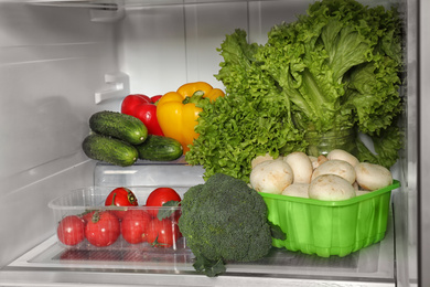 Photo of Open refrigerator full of different fresh products