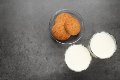 Glasses of milk and oatmeal cookies on table. Fresh dairy product