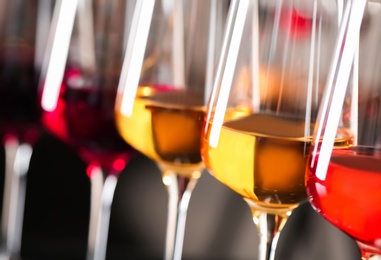 Photo of Row of glasses with different wines on blurred background, closeup