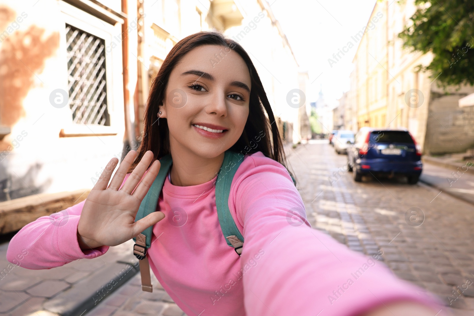 Photo of Beautiful young travel blogger streaming on city street