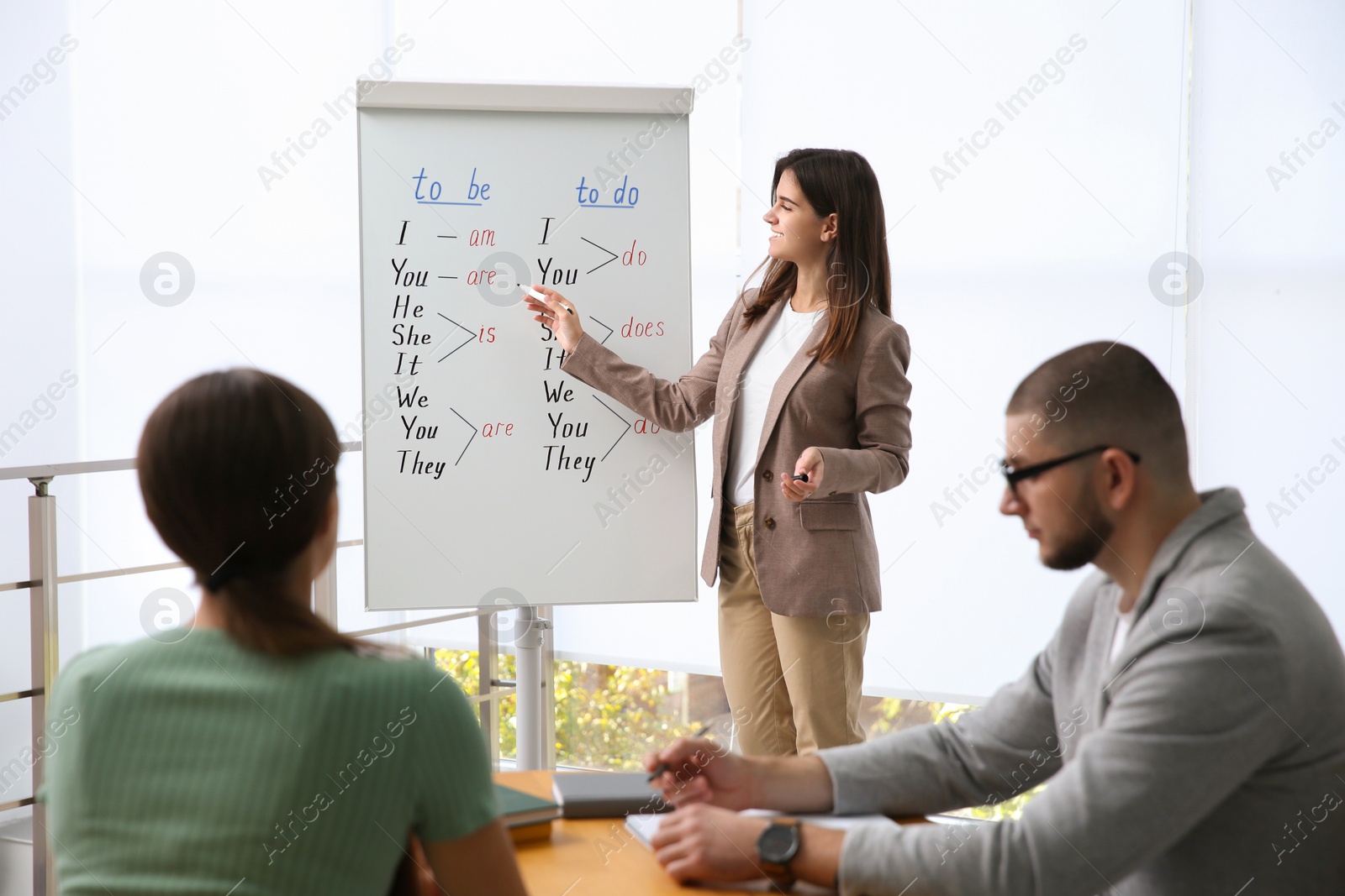 Photo of English teacher with students in class at lesson