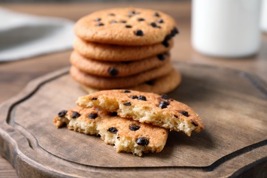 Delicious cookies with chocolate on wooden board, closeup