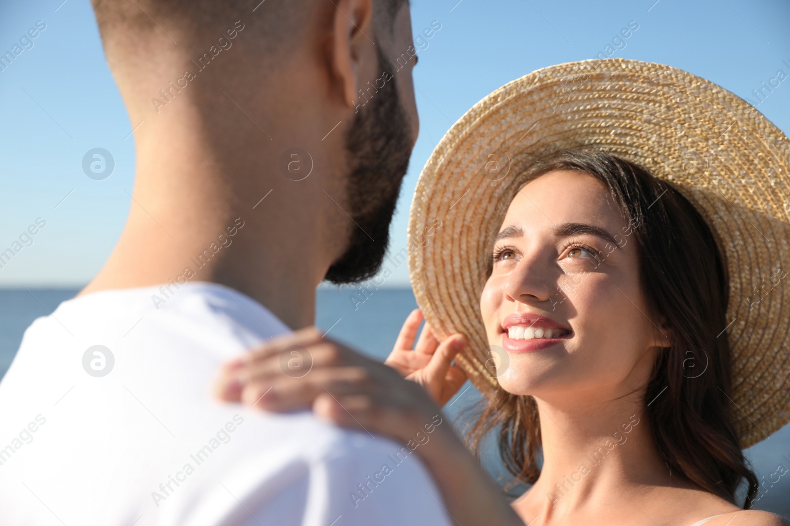 Photo of Happy young couple at beach, closeup. Honeymoon trip