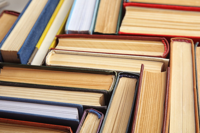 Photo of Many different hardcover books as background, closeup