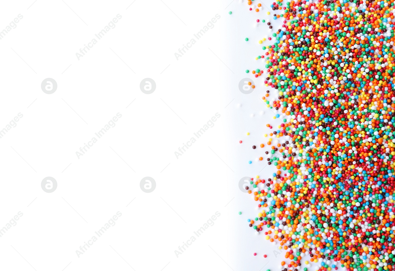 Photo of Colorful sprinkles on white background, top view. Confectionery decor