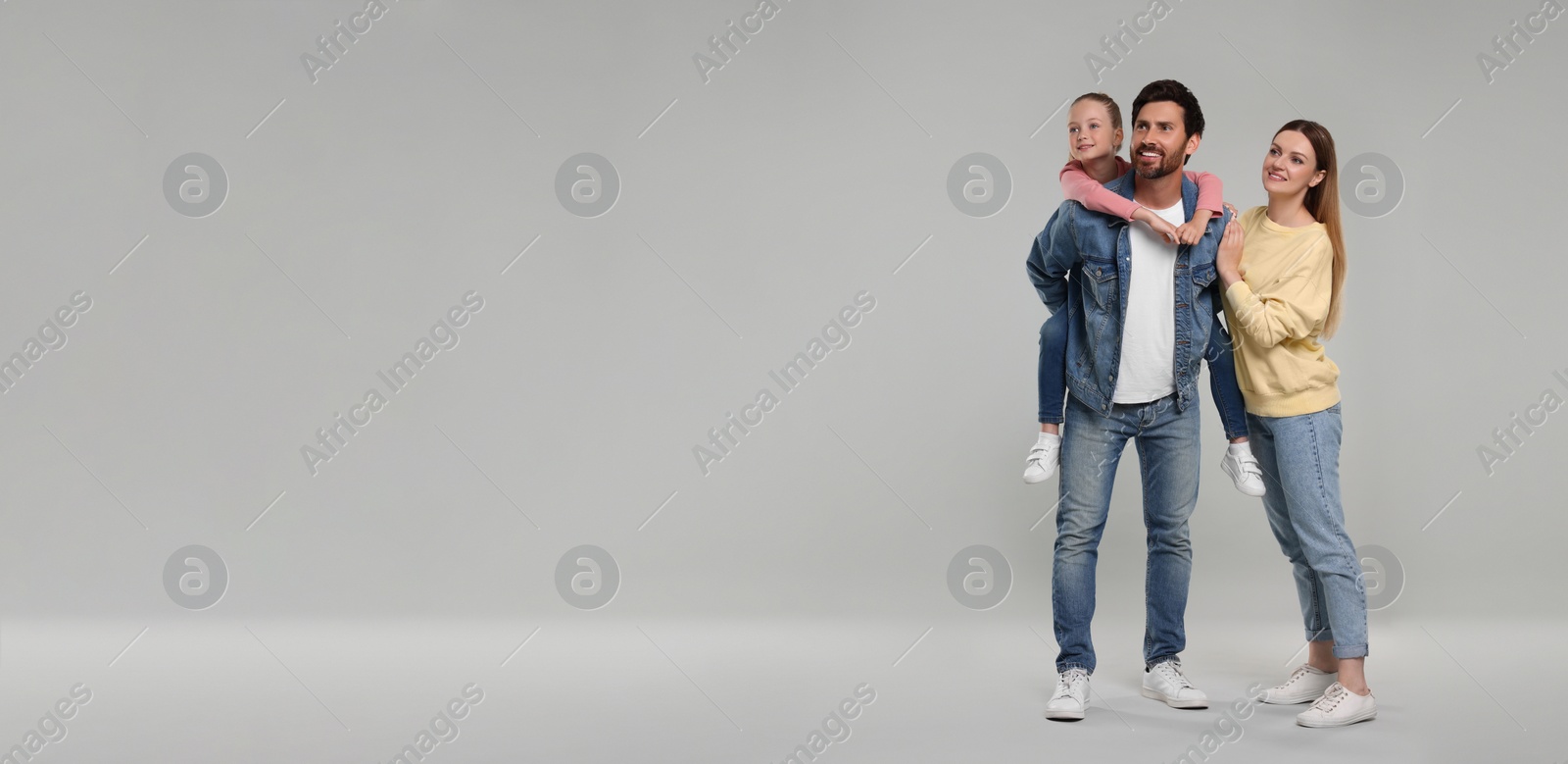 Image of Happy family with child on light grey background, space for text. Banner design