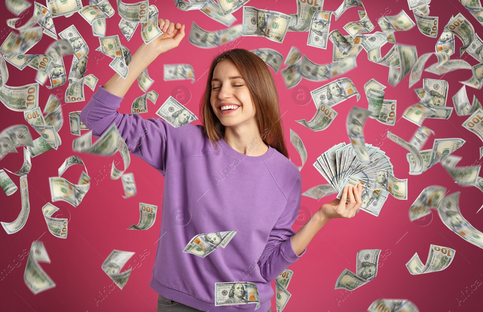 Image of Happy young woman with dollars under money rain on pink background