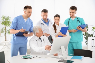 Photo of Group of doctors attending meeting in clinic. Cardiology conference