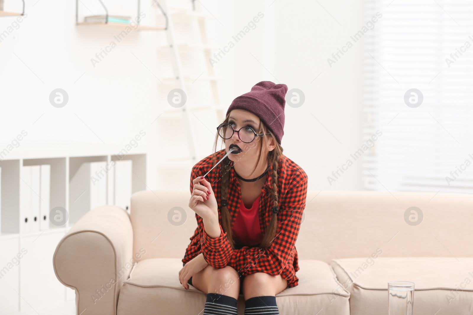 Photo of Teenage girl sitting on sofa in psychotherapist office