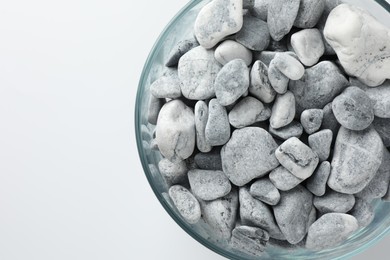 Photo of Presentation for product. Glass container with stones on light grey background, top view. Space for text