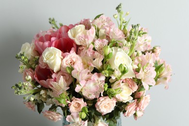 Photo of Beautiful bouquet of fresh flowers on light background