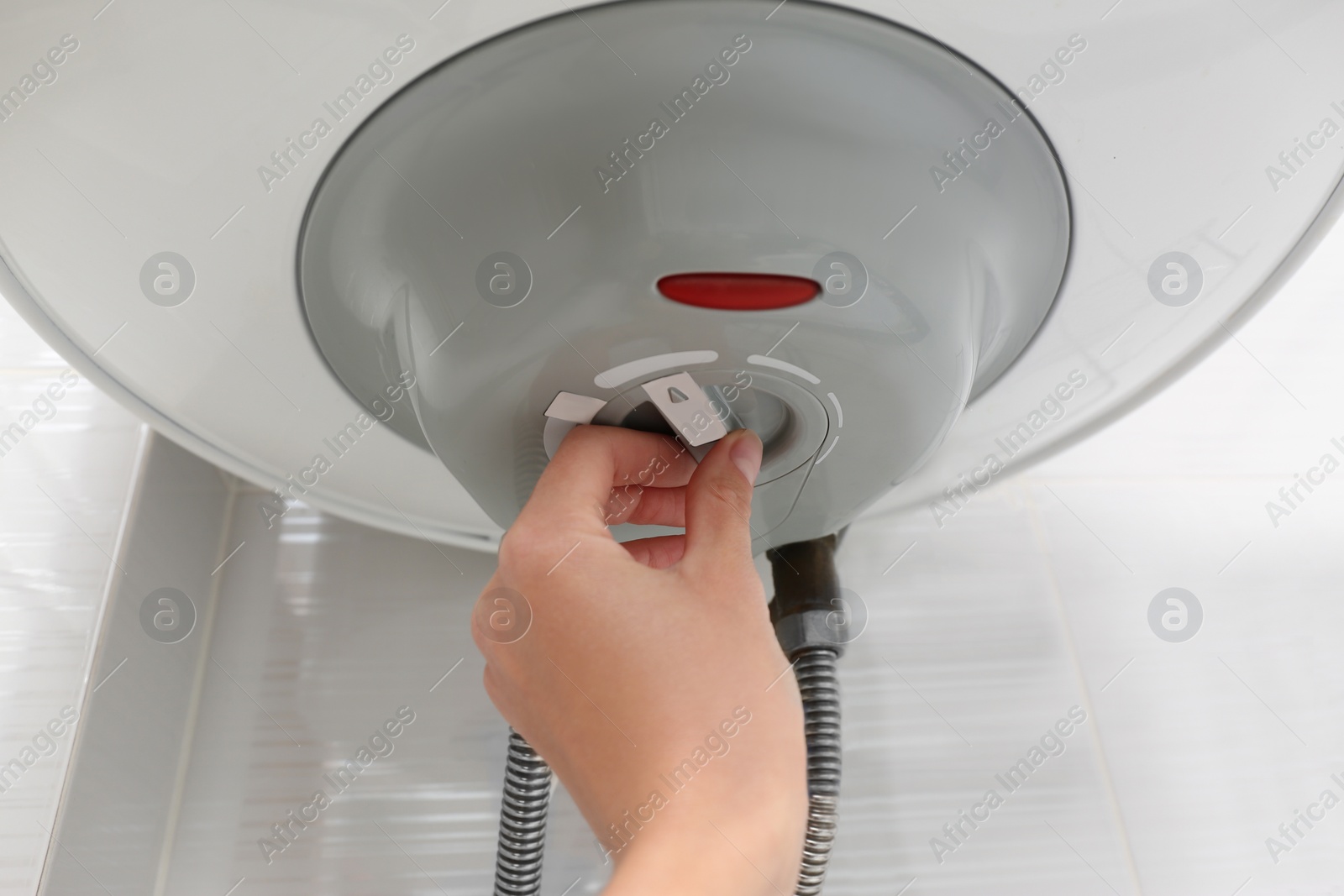 Photo of Woman adjusting maximum energy efficiency indicator indoors, closeup. Boiler installation