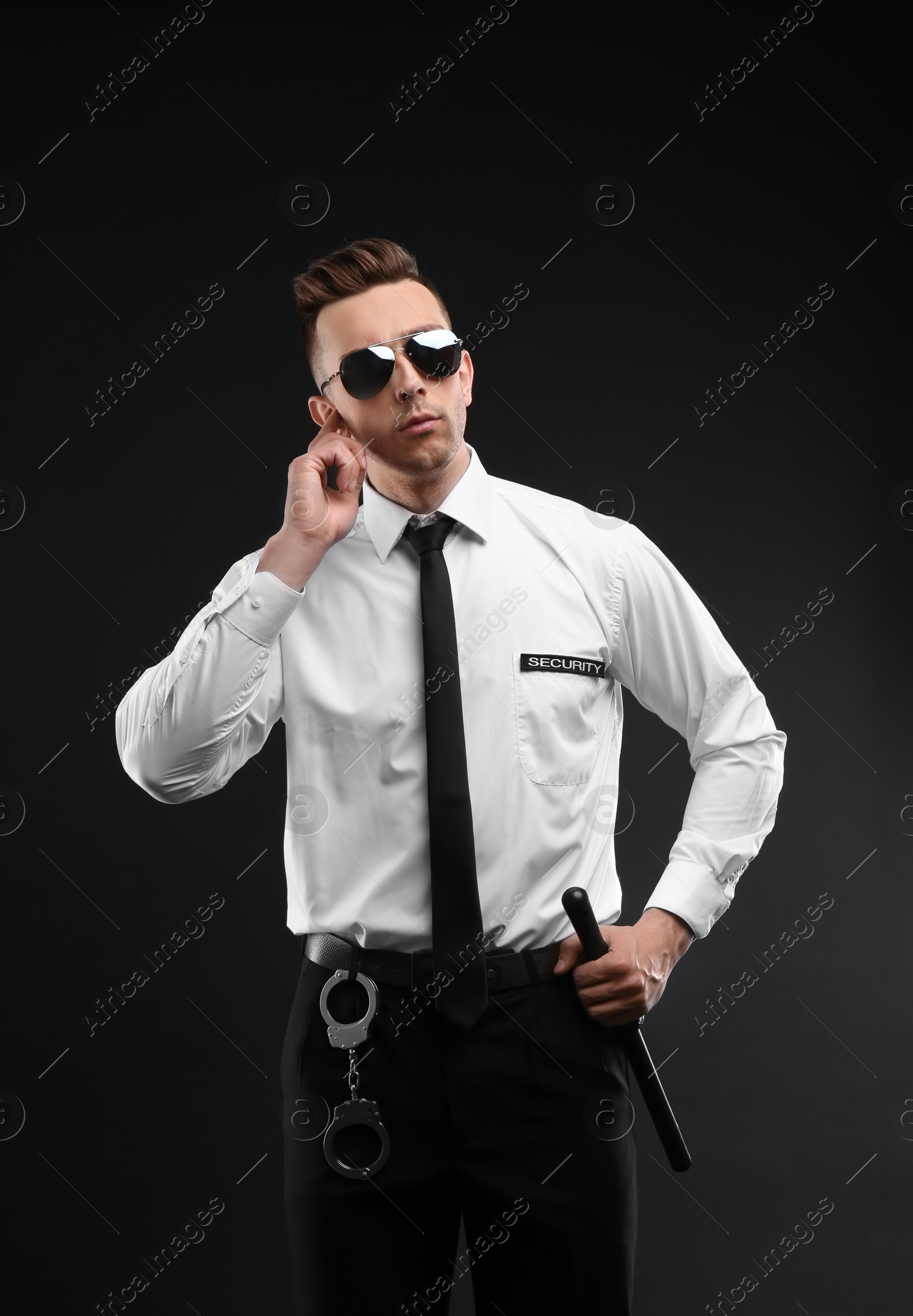 Photo of Male security guard in uniform on dark background