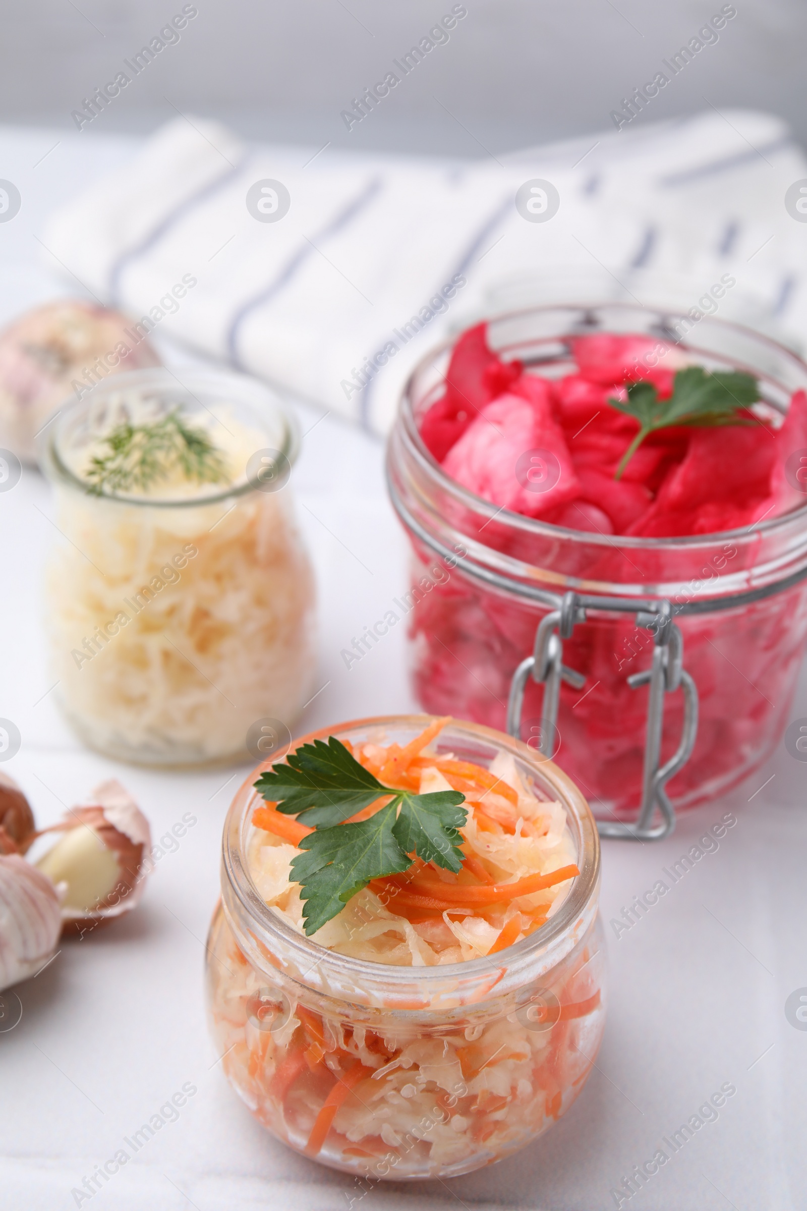 Photo of Delicious sauerkraut prepared according to different recipes on white table, closeup