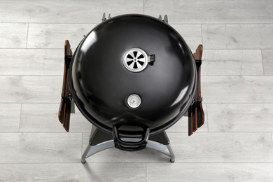 New modern barbecue grill on wooden floor