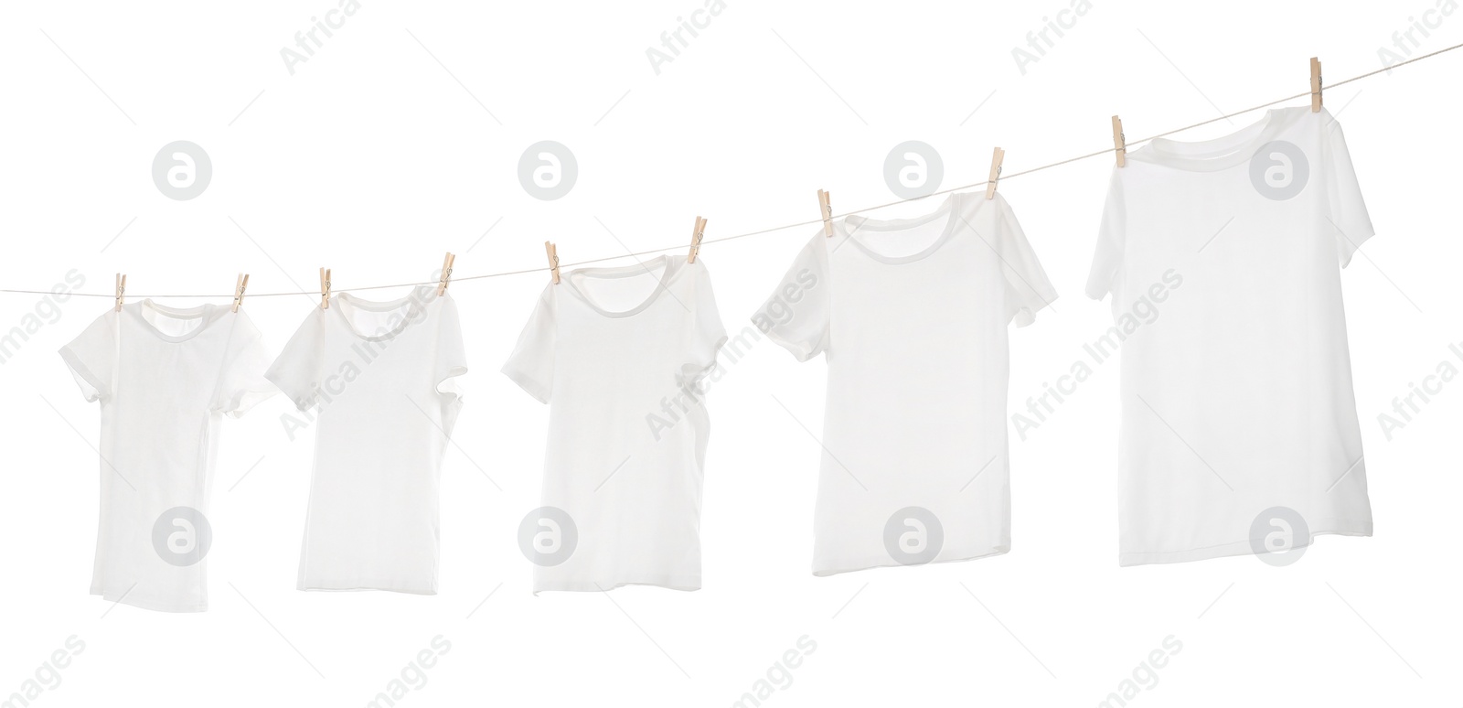 Photo of Many t-shirts drying on washing line isolated on white