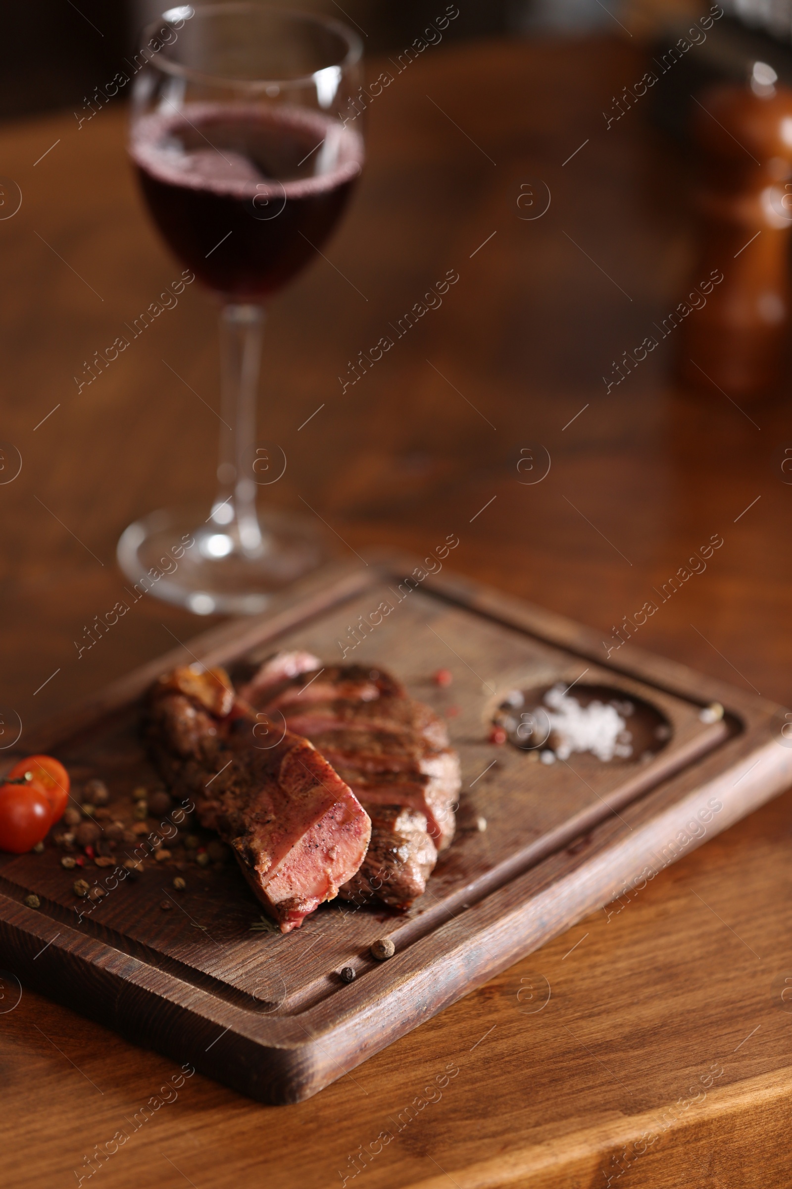 Photo of Tasty roasted meat served on wooden table. Cooking food