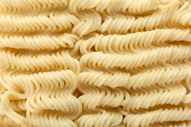 Photo of Quick cooking noodles as background, closeup view