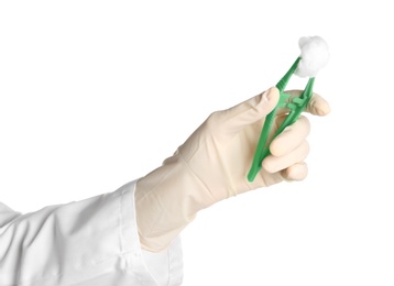 Photo of Doctor in medical glove holding disposable forceps with cotton ball on white background