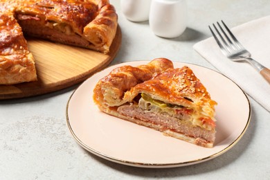 Photo of Piece of tasty homemade pie with filling on light grey table