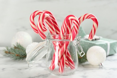Photo of Christmas candy canes on white marble table