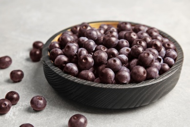 Photo of Plate with fresh acai berries on table