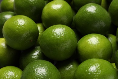 Photo of Many fresh ripe limes as background, closeup