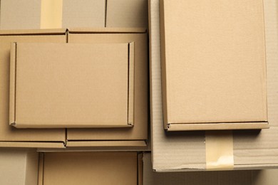 Photo of Many cardboard boxes as background, top view. Packaging goods