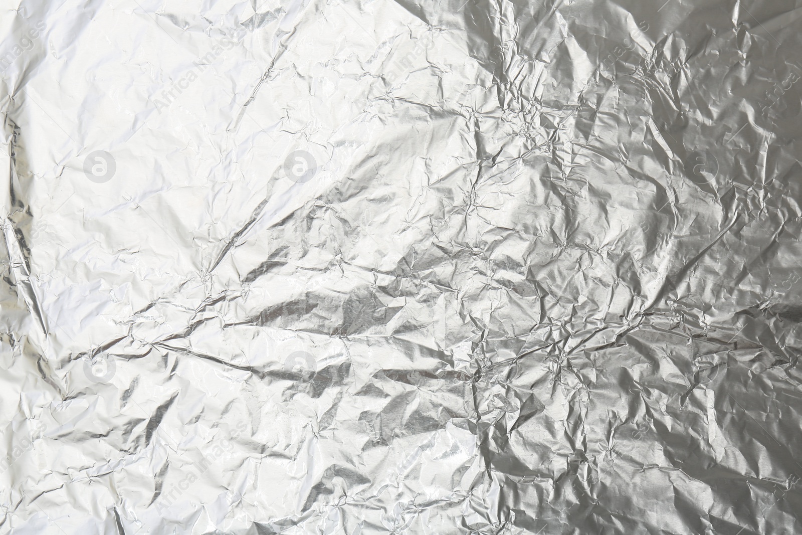 Photo of Crumpled silver foil as background, top view