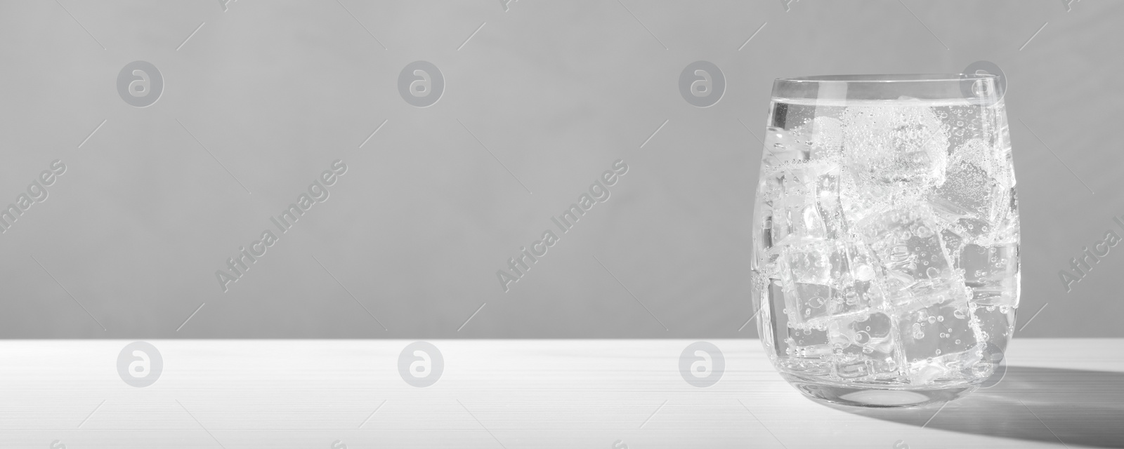 Image of Refreshing soda water on white wooden table. Banner design with space for text