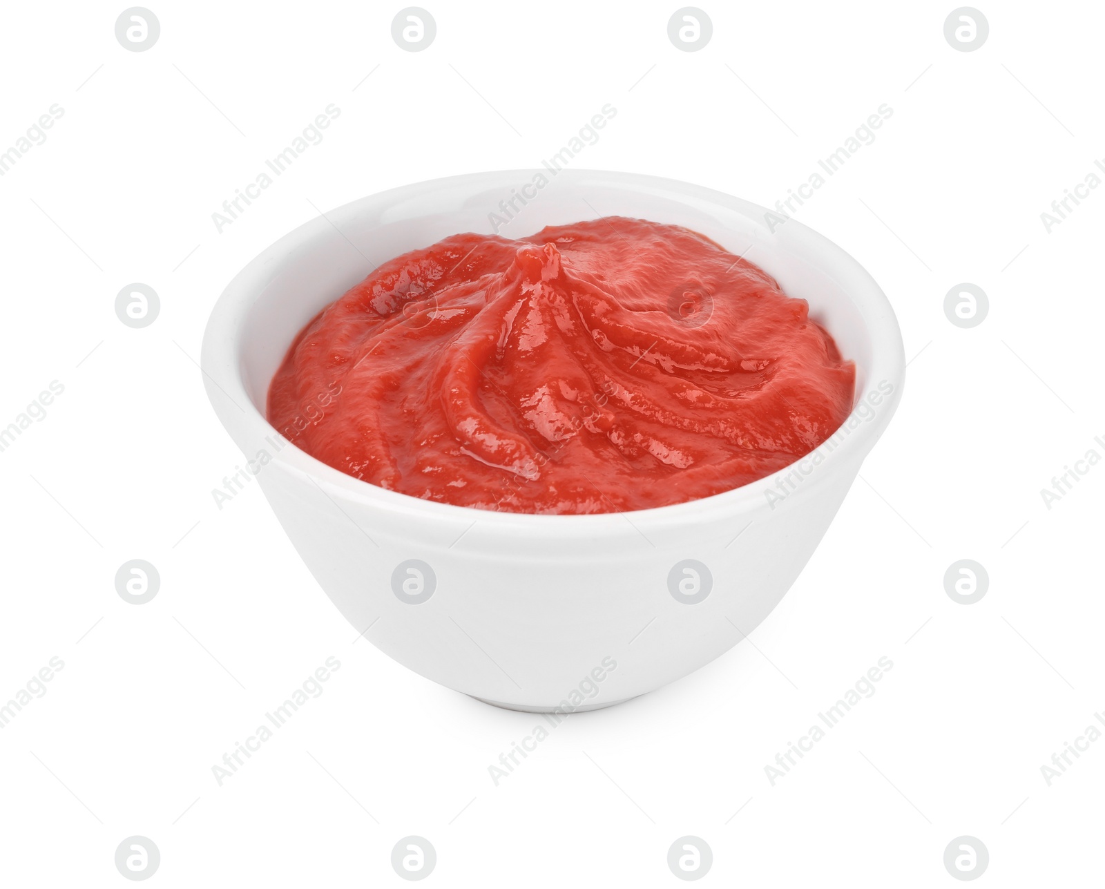 Photo of Organic ketchup in bowl isolated on white. Tomato sauce