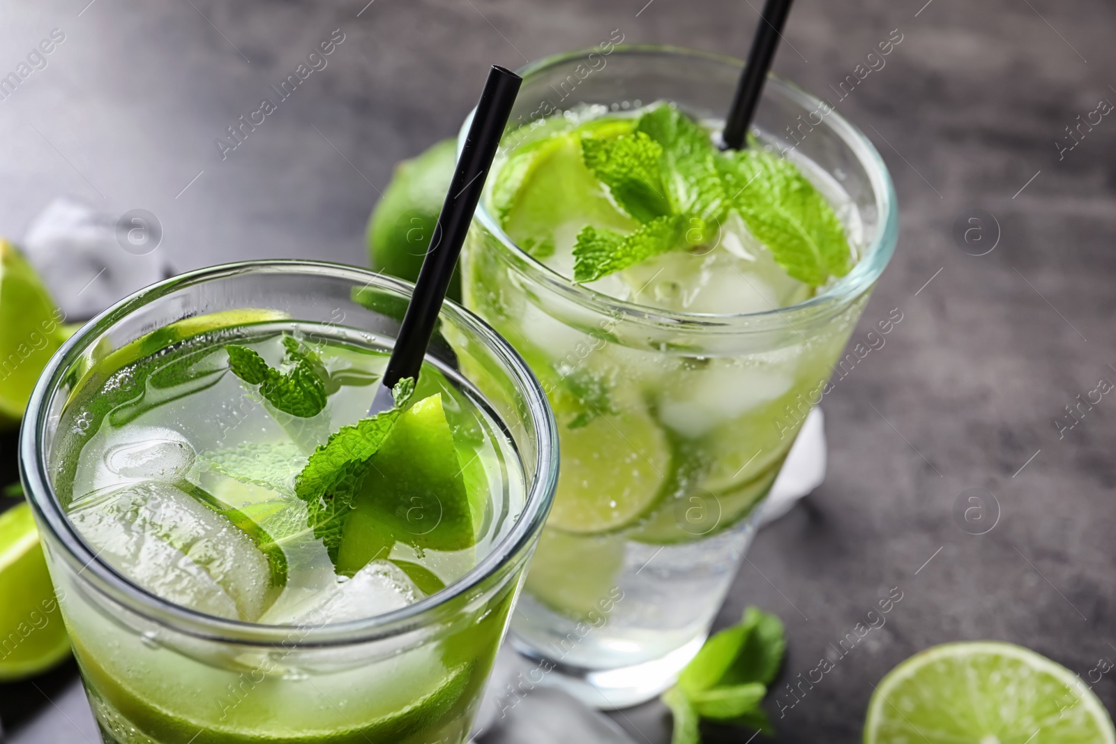 Photo of Refreshing beverage with mint and lime on table, closeup