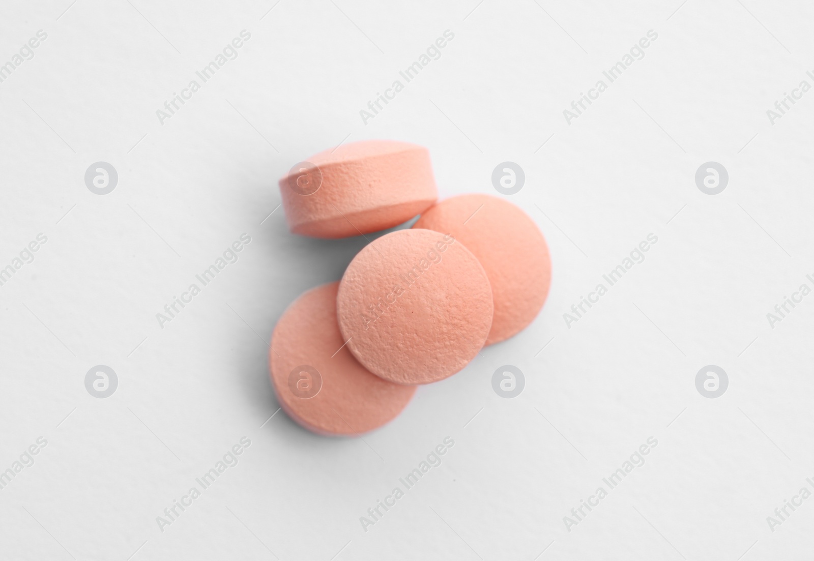 Photo of Color pills on white background, top view. Medical treatment