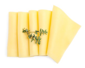 Slices of tasty fresh cheese and thyme isolated on white, top view