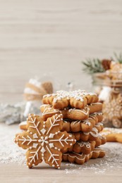 Tasty Christmas cookies on beige wooden table