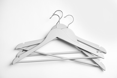 Photo of Empty clothes hangers on white background, top view