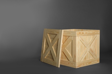 Photo of Wooden crate with lid on dark background, space for text