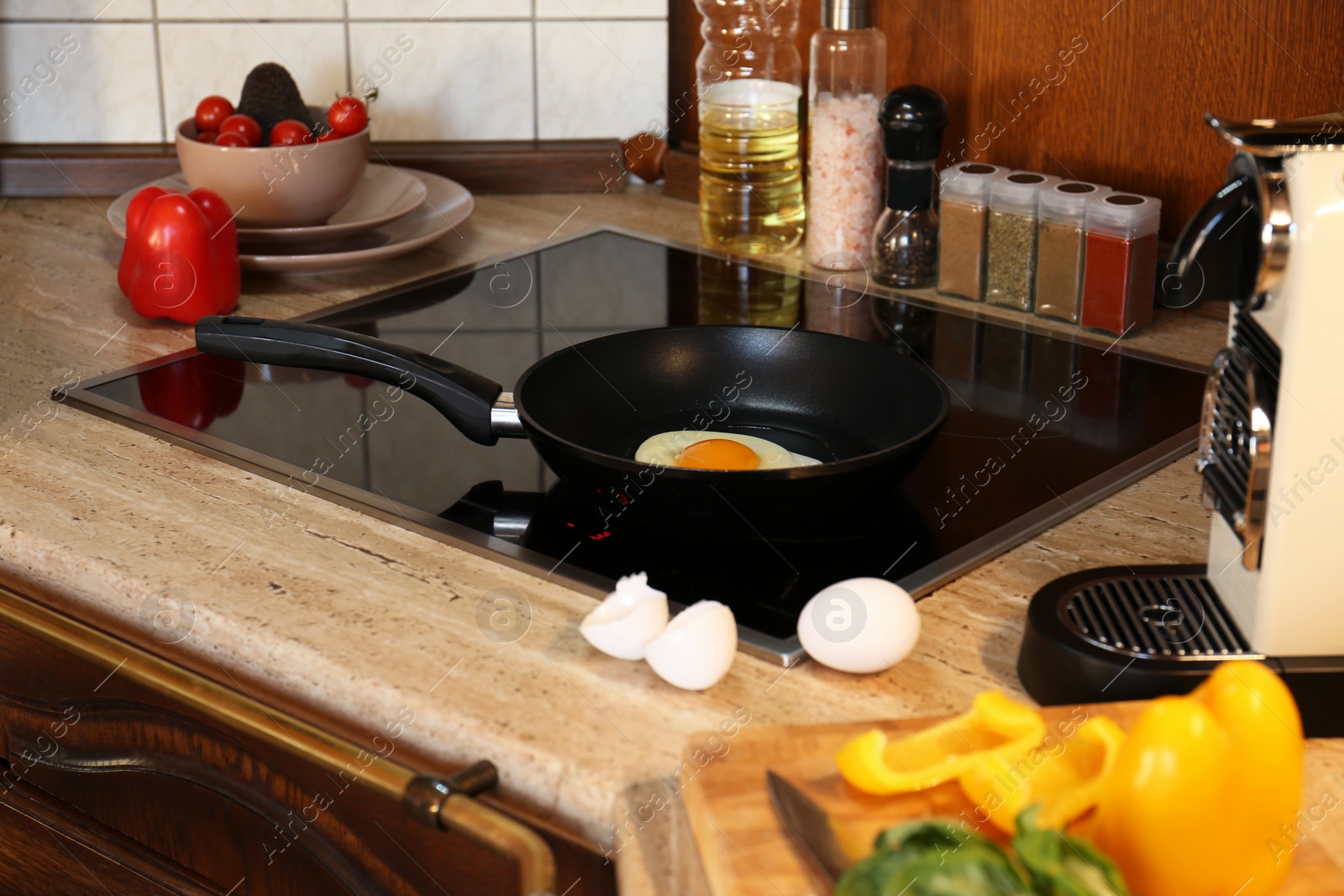 Photo of Frying eggs for tasty breakfast in kitchen