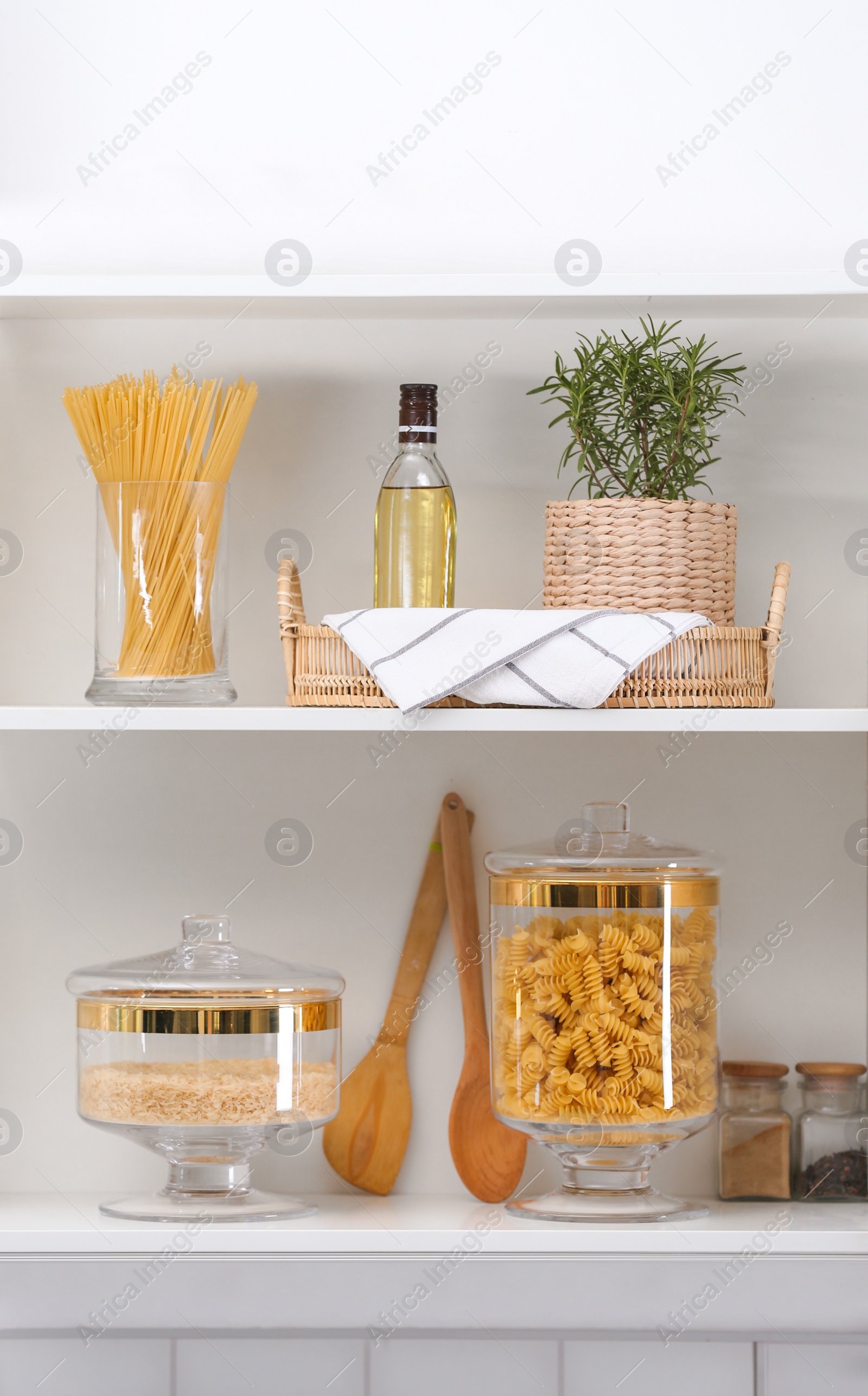 Photo of Shelves with raw foodstuff in modern kitchen