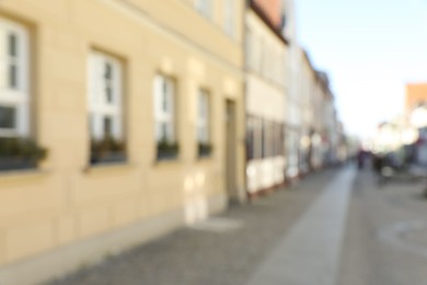 Photo of Blurred view of city street with beautiful buildings. Bokeh effect