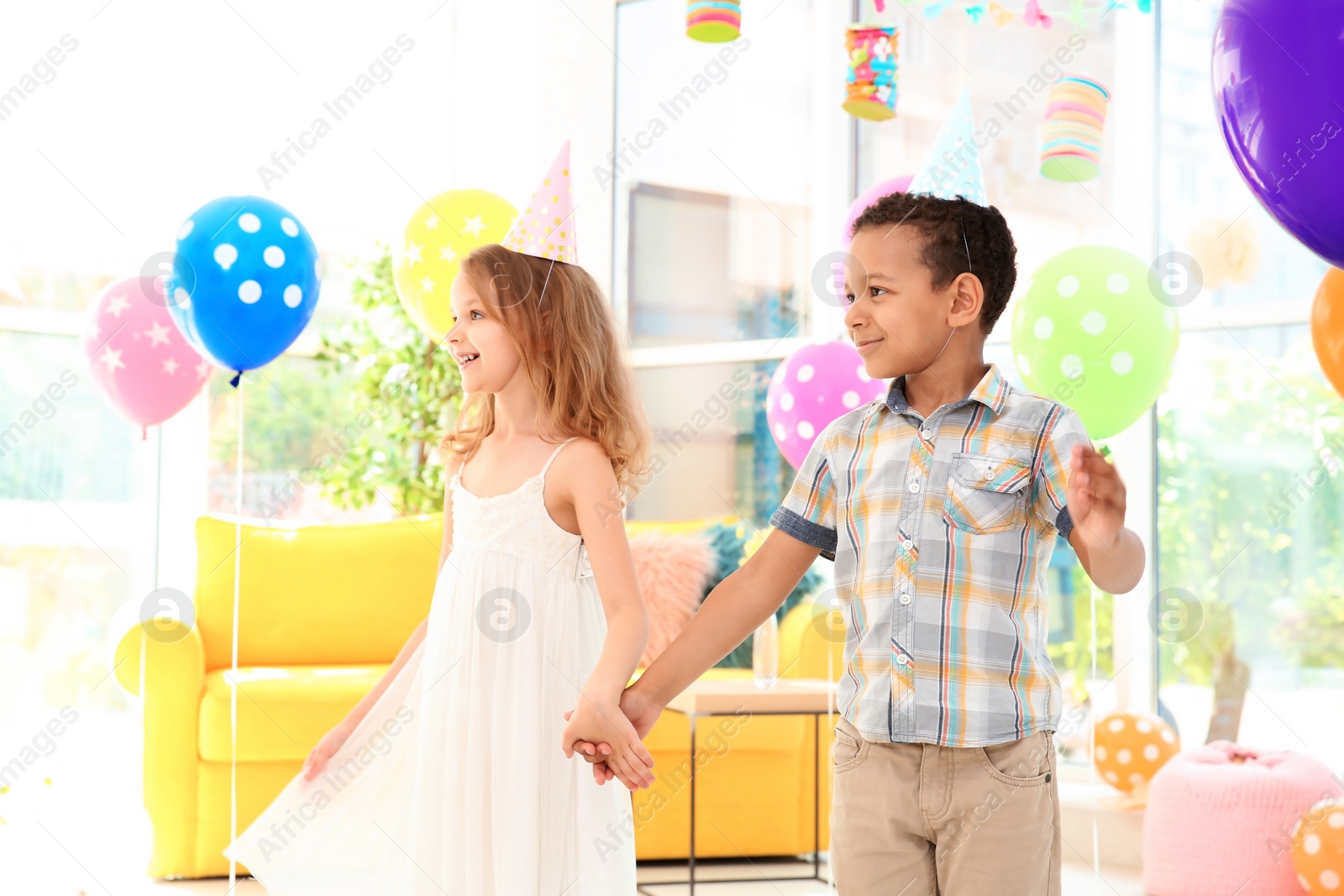 Photo of Cute little children at birthday party indoors