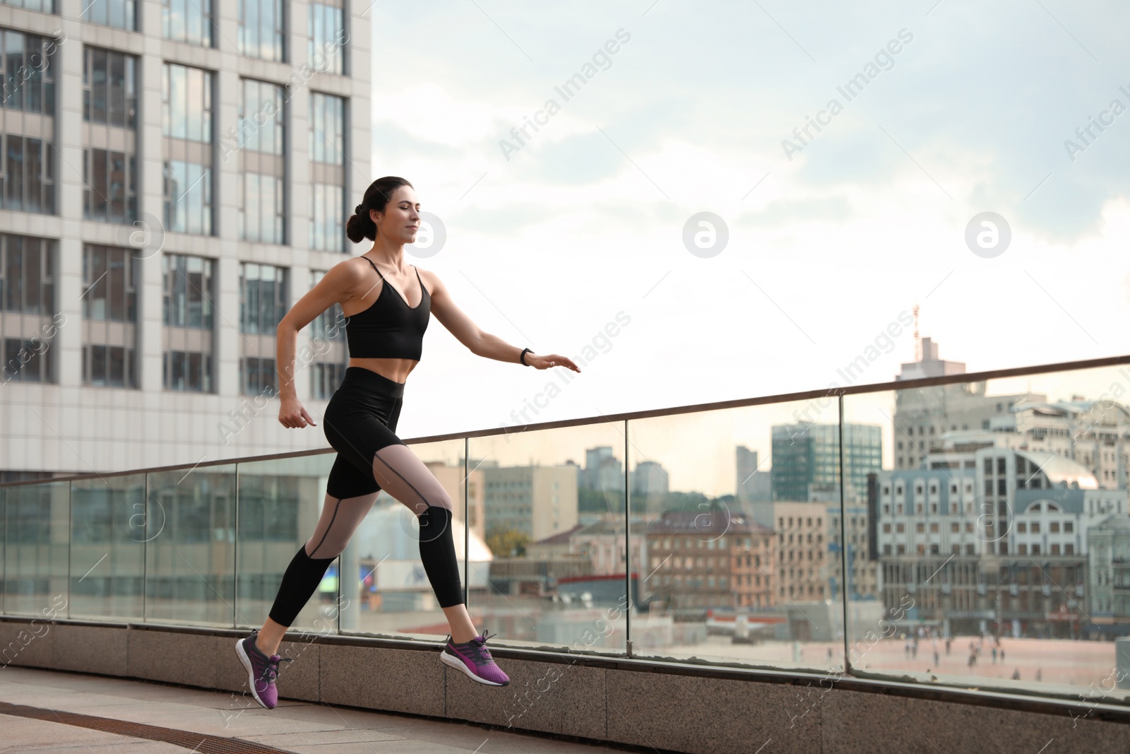 Photo of Beautiful sporty young woman running on street