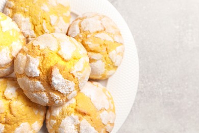 Photo of Plate with tasty lemon cookies on grey table, top view