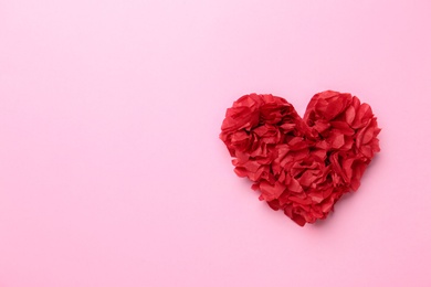 Red heart on pink background, top view. Space for text