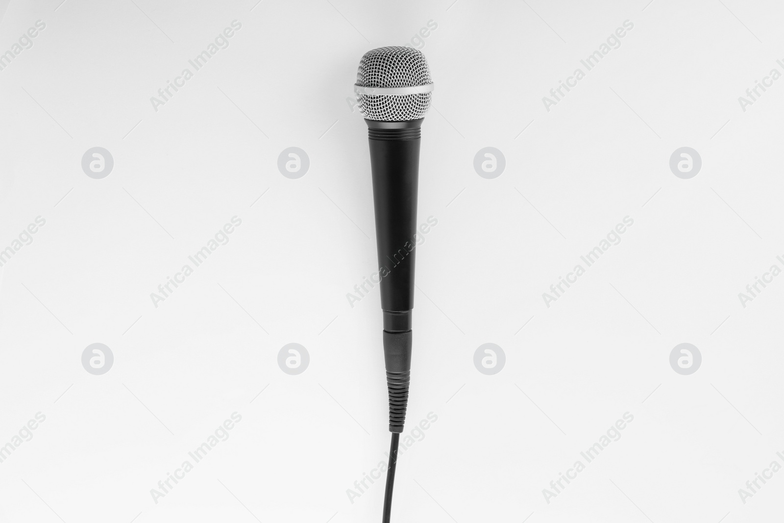 Photo of Microphone with wire on white background, top view