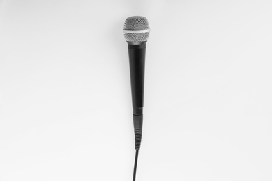 Photo of Microphone with wire on white background, top view