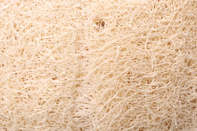 Photo of Loofah sponge as background, closeup. Personal hygiene product