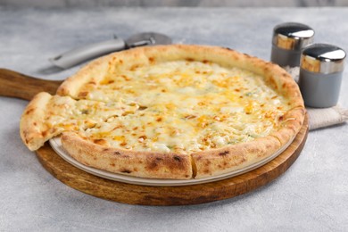 Delicious cheese pizza on light grey textured table