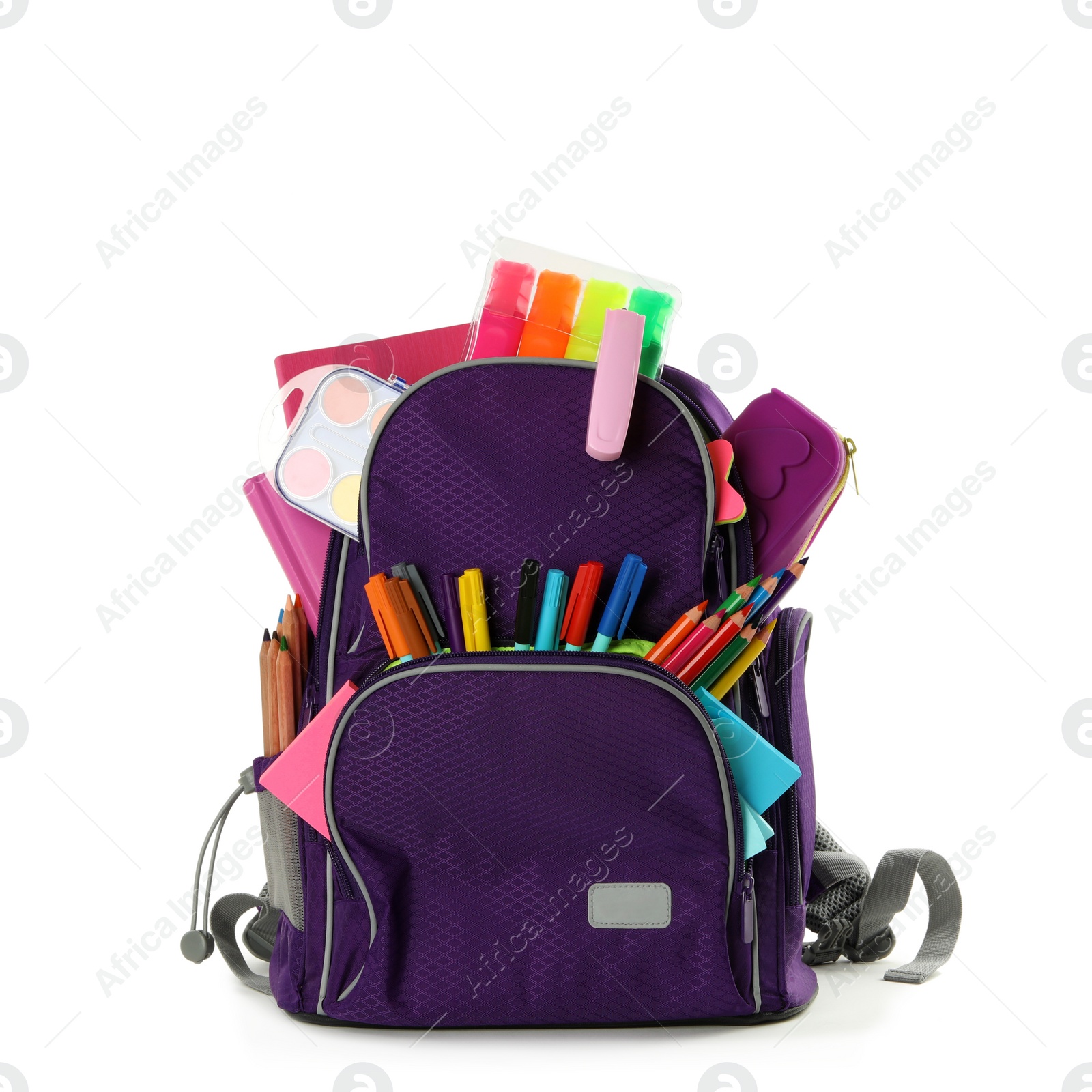 Photo of Purple backpack with different school stationery on white background