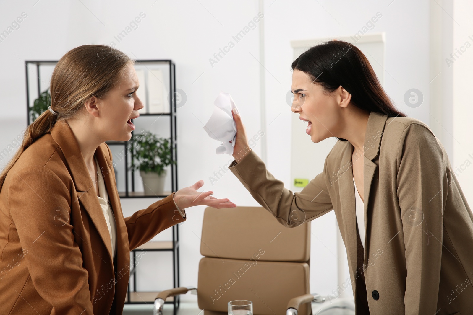 Photo of Emotional colleagues arguing in office. Toxic work environment